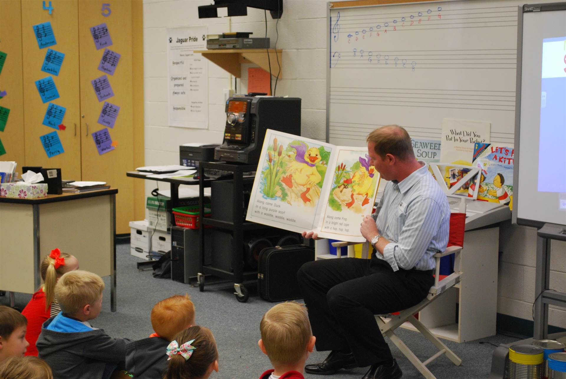 Music teacher reading to students. 