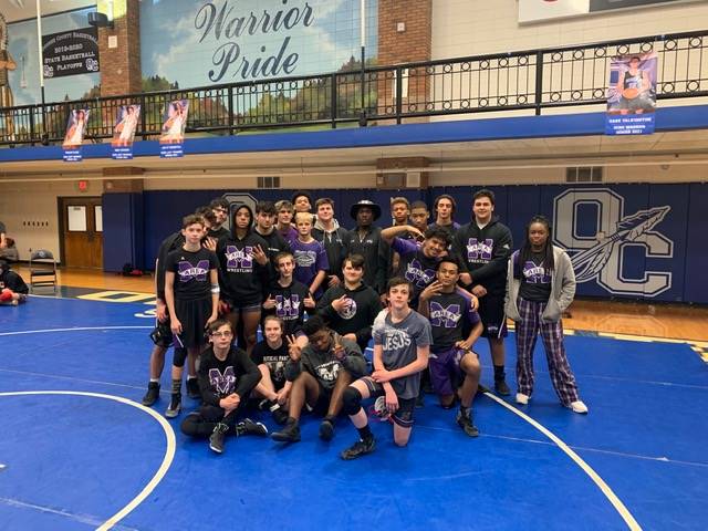 A group of students in wrestling uniforms.