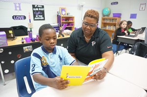 teacher reading with student
